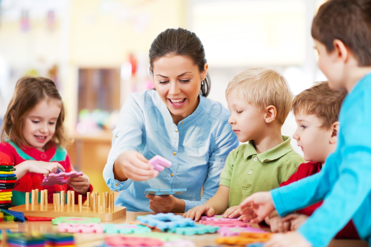 Nursery teacher playing with the kids